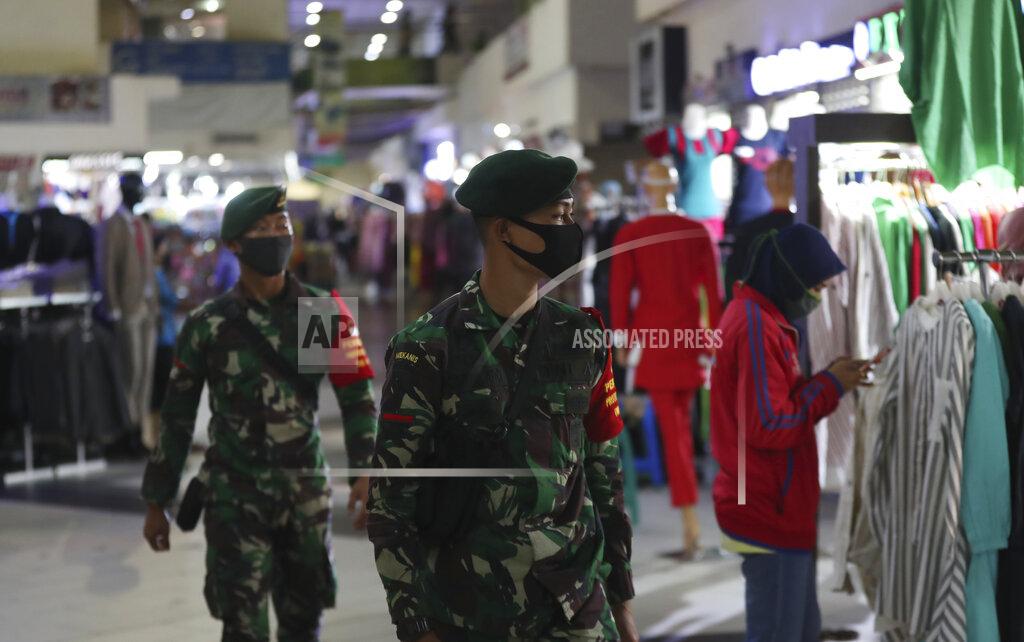 Achmad Ibrahim Indonesian soldiers wearing face mask patrol amid fears of the new coronavirus outbreak at a market in Jakarta, Indonesia Tuesday, June 30, 2020.(AP Photo/Achmad Ibrahim)