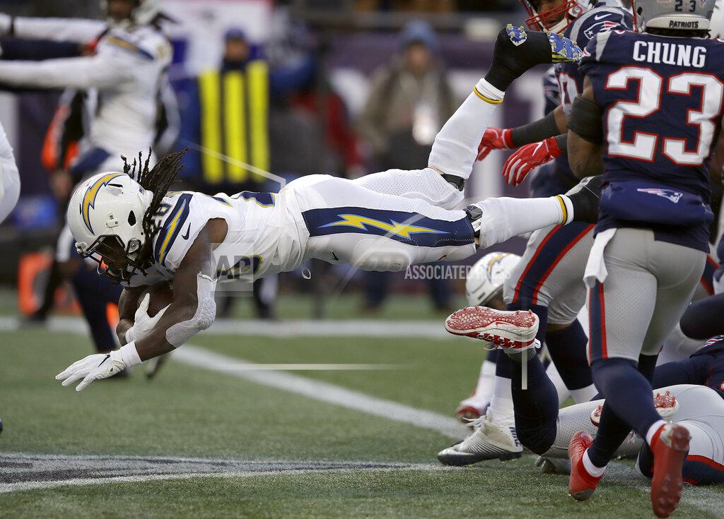 Charles Krupa Los Angeles Chargers running back Melvin Gordon, left, dives into the end zone for a touchdown during the second half of an NFL divisional playoff football game against the New England Patriots, Sunday, Jan. 13, 2019, in Foxborough, Mass. (AP Photo/Charles Krupa)