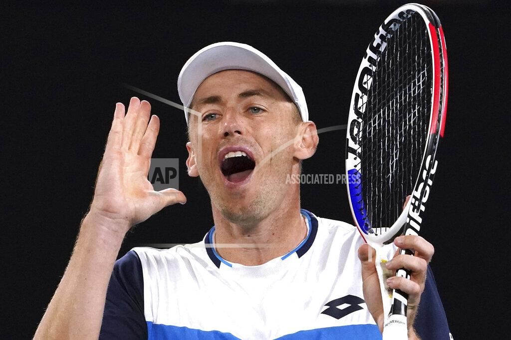FILE - In this Jan. 24, 2020, file photo, Australia's John Millman reacts during his third round match against Switzerland's Roger Federer at the Australian Open tennis championship in Melbourne, Australia. Just four matches after his five-setter against Federer on one of the biggest stages in tennis, Millman was having to scramble to find a practice court. (AP Photo/Lee Jin-man, File)