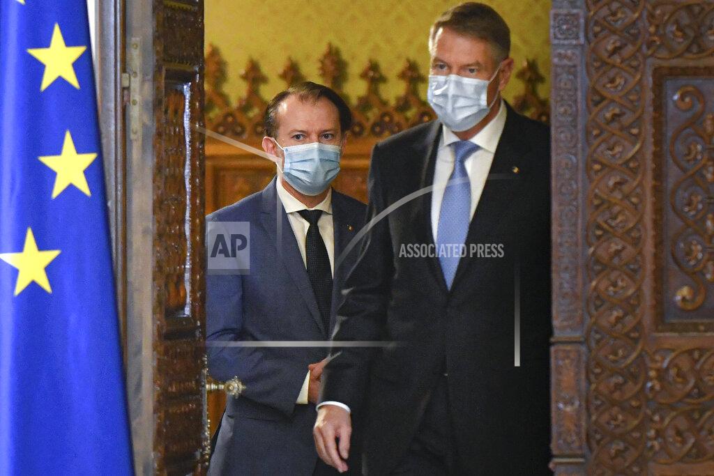 Andreea Alexandru Romanian prime minister-designate Florin Citu, left, walks next to Romanian President Klaus Iohannis shortly before his nomination in Bucharest, Romania, Tuesday, Dec. 22, 2020. Romania's president on Tuesday appointed the outgoing finance minister as prime minister-designate after three pro-Western center-right groups joined forces to keep out of power a left-leaning populist party that won most votes at a parliamentary election earlier this month. (AP Photo/Andreea Alexandru)