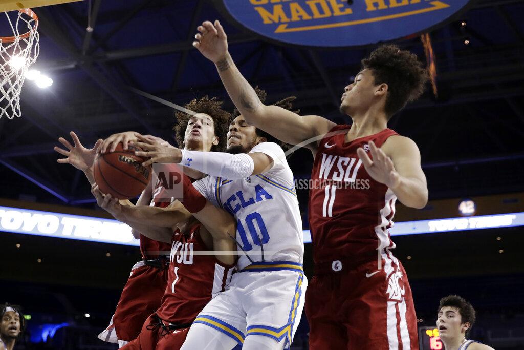 Marcio Jose Sanchez UCLA guard Tyger Campbell (10) vies for a rebound against Washington State guard Jervae Robinson (1) and forward DJ Rodman (11) during the first half of an NCAA college basketball game Thursday, Feb. 13, 2020, in Los Angeles. (AP Photo/Marcio Jose Sanchez)