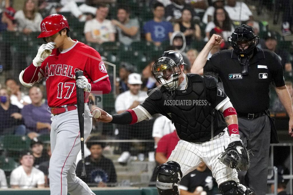 Charles Rex Arbogast Chicago White Sox catcher Yasmani Grandal, center, tags out Los Angeles Angels' Shohei Ohtani after a dropped third strike, as home plate umpire Bill Welke makes the call during the ninth inning of a baseball game Tuesday, Sept. 14, 2021, in Chicago. The White Sox won 9-3. (AP Photo/Charles Rex Arbogast)