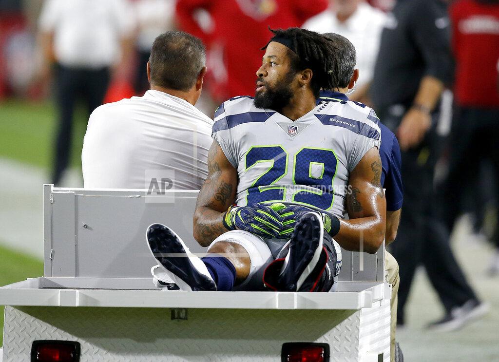 Ross D. Franklin File - In this Sept. 30, 2018, file photo, Seattle Seahawks defensive back Earl Thomas (29) leaves the field after breaking his leg against the Arizona Cardinals during the second half of an NFL football game in Glendale, Ariz. Though the league's biggest stars receive hefty signing bonuses, the push for more guaranteed money across the life of contracts has slowly picked up steam over the past few seasons. The contract holdouts by Le'Veon Bell and Thomas during this season put the issue into vivid focus. (AP Photo/Ross D. Franklin, File)