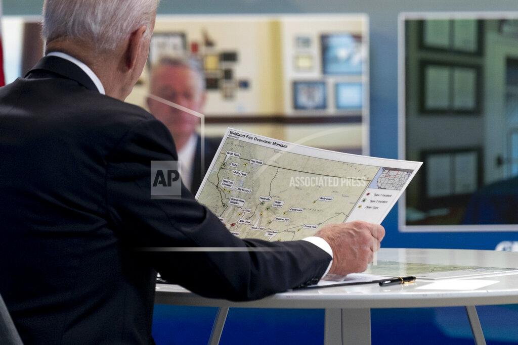 Andrew Harnik President Joe Biden looks at a map of wildfires in Montana as he speaks with governors about ongoing efforts to strengthen wildfire prevention, preparedness and response efforts, and hear firsthand about the ongoing impacts of the 2021 wildfire season in the South Court Auditorium in the Eisenhower Executive Office Building on the White House Campus in Washington, Friday, July 30, 2021. (AP Photo/Andrew Harnik)