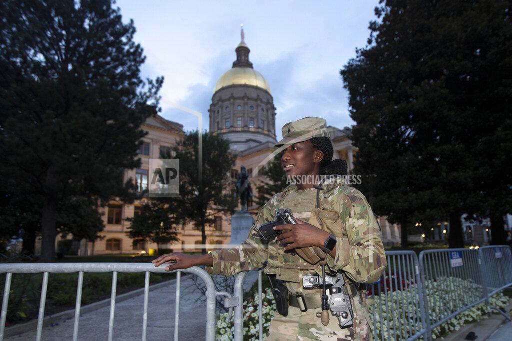 John Bazemore A member of the Georgia National Guard stands outside the State Capitol on Tuesday, July 7, 2020, in Atlanta. Georgia Gov. Brian Kemp mobilized the guard after a surge in gun violence in the city over the weekend. (AP Photo/John Bazemore)