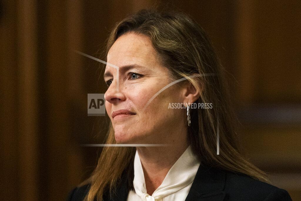 FILE - In this Oct. 1, 2020, file photo Supreme Court nominee Judge Amy Coney Barrett, listens as Sen. Steve Daines, R-Mont., speaks during their meeting on Capitol Hill in Washington. A scant two weeks after her nomination, Judge Amy Coney Barrett goes before a Senate committee that’s bitterly split along partisan lines over whether the Supreme Court vacancy created by Justice Ruth Bader Ginsburg’s death should be filled now or should await the winner of the Nov. 3 presidential election. (AP Photo/Manuel Balce Ceneta, Pool, File)