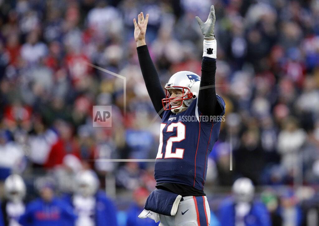 FILE - In this Dec. 24, 2017, file photo, New England Patriots quarterback Tom Brady celebrates a touchdown by running back Dion Lewis during the second half of the team's NFL football game against the Buffalo Bills in Foxborough, Mass. Brady’s .774 regular season winning percentage ranks first in the Super Bowl era among quarterbacks with at least 50 starts. With 249 victories overall, including playoffs, he’s won almost as many games in two decades as the Tampa Bay Buccaneers have won (273) in the franchise’s 44-season history. (AP Photo/Charles Krupa, File)
