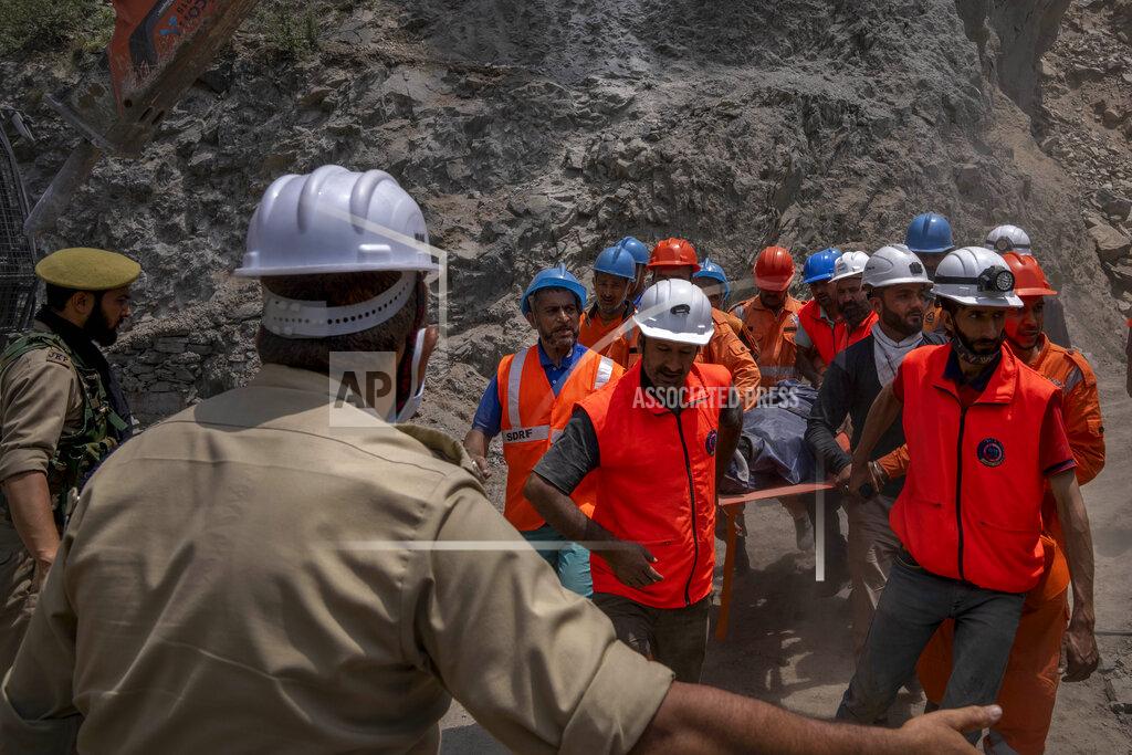 Dar Yasin Rescue workers carry the body of a victim at the site of a collapsed tunnel in Ramban district, south of Srinagar, Indian controlled Kashmir, Friday, May 20, 2022. An official in Indian-controlled Kashmir said Friday that 10 workers were trapped after part of a road tunnel collapsed in the Himalayan region. (AP Photo/Dar Yasin)