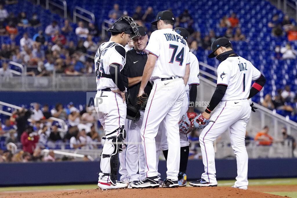 Lynne Sladky Miami Marlins starting pitcher Zach Thompson (74) talks with catcher Alex Jackson (23) and pitching coach Mel Stottlemyre, center, with the bases loaded during the second inning of a baseball game against the New York Mets, Wednesday, Aug. 4, 2021, in Miami. (AP Photo/Lynne Sladky)