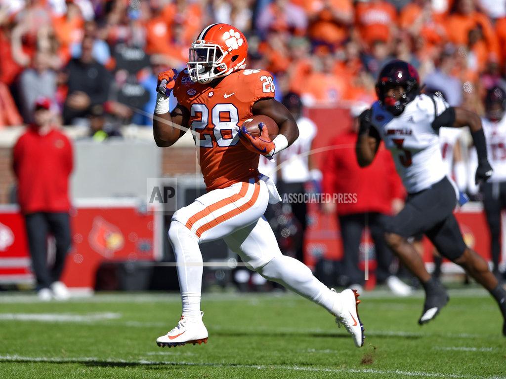 Richard Shiro Clemson's Tavien Feaster rushes for a 70-yard touchdown while pursued by Louisville's Cornelius Sturghill during the first half of an NCAA college football game Saturday, Nov. 3, 2018, in Clemson, S.C. (AP Photo/Richard Shiro)
