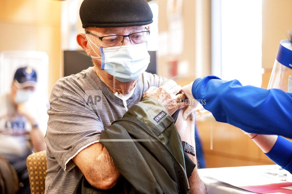 Noah Berger Jim Clark, 86, receives a first dose of Pfizer-BioNTech COVID-19 vaccine from UC Davis Health on Tuesday, Jan. 12, 2021, in Sacramento, Calif. (AP Photo/Noah Berger, Pool)