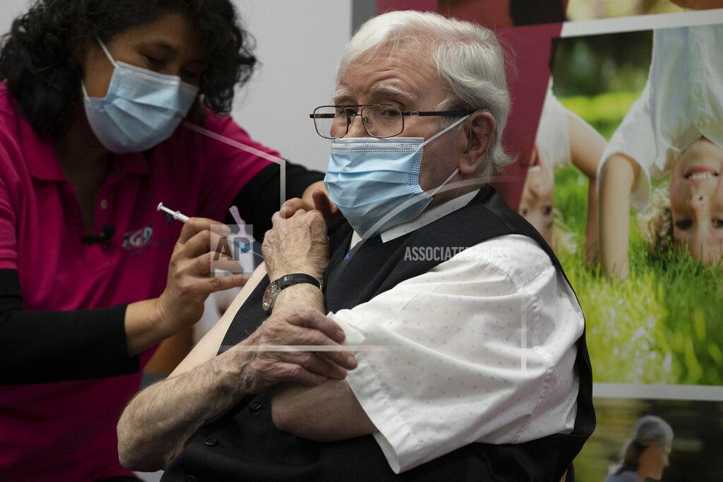Peter Dejong Okko Molenkamp, 94, is injected with a COVID-19 vaccine in Apeldoorn, Netherlands, Tuesday, Jan. 26, 2021. Dutch authorities began vaccinating the first of thousands of people aged over 90 years who still live at home. (AP Photo/Peter Dejong)