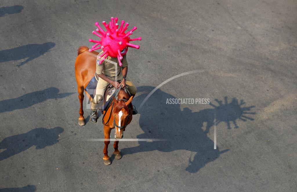 Mahesh Kumar A An Indian policeman wearing a virus themed helmet rides on a horse during an awareness rally aimed at preventing the spread of new coronavirus in Hyderabad, India, Thursday, April 2, 2020. The new coronavirus causes mild or moderate symptoms for most people, but for some, especially older adults and people with existing health problems, it can cause more severe illness or death. (AP Photo/Mahesh Kumar A.)