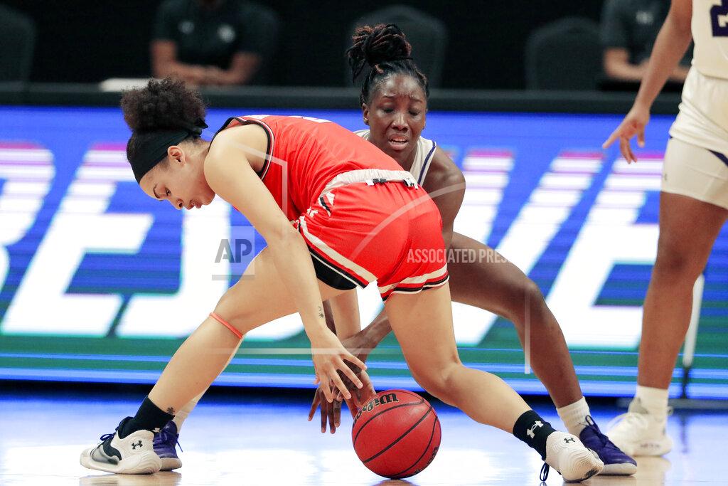 Michael Wyke Sam Houston State forward Amber Leggett, left, and Stephen F. Austin guard Tasharian Robinson, right, battle for a loose ball during the first half of an NCAA college basketball game for the Southland Conference women's tournament championship Sunday, March 14, 2021, in Katy, Texas. (AP Photo/Michael Wyke)