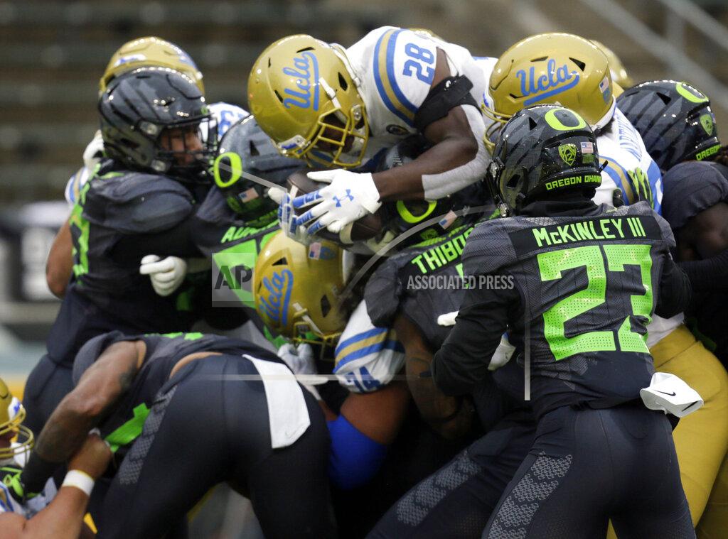 Chris Pietsch UCLA's Brittain Brown, center, leaps into the end zone for a third-quarter score against Oregon in an NCAA college football game Saturday, Nov. 21, 2020, in Eugene, Ore. (AP Photo/Chris Pietsch)