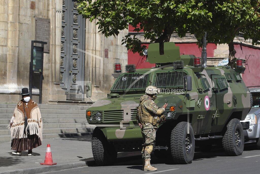 Martin Mejia Soldiers stand guard in Plaza Murillo where the Cathedral and government offices are located in La Paz, Bolivia, Monday, Oct. 19, 2020, the morning after general elections. Results trickled in from Bolivia’s presidential election, a high-stakes redo of last year’s annulled ballot that saw president Evo Morales resign and flee the country. (AP Photo/Martin Mejia)