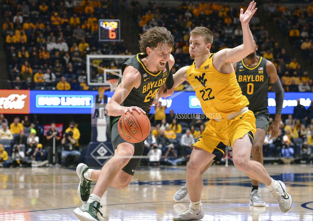 William Wotring Baylor guard Matthew Mayer (24) drives to the net while being guarded by West Virginia guard Sean McNeil (22) during the second half of an NCAA college basketball game in Morgantown, W.Va., Tuesday, Jan. 18, 2022. (William Wotring)