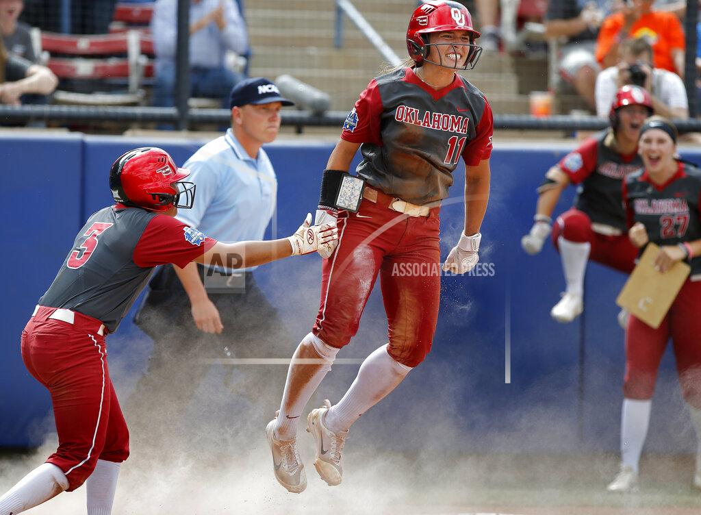 Sarah Phipps FILE - Oklahoma's Nicole Mendes (11) and Kelsey Arnold (3) celebrate scoring in the fifth inning during the Women's College World Series softball game between the against Oregon at ASA Hall of Fame Stadium in Oklahoma City, in this Sunday, June 4, 2017. Division I softball is providing a training ground this season for players preparing for the 2021 Olympics. Oklahoma’s Nicole Mendes and North Carolina State’s Tatyana Forbes will play for Mexico, their schools said. (Sarah Phipps/The Oklahoman via AP, File)