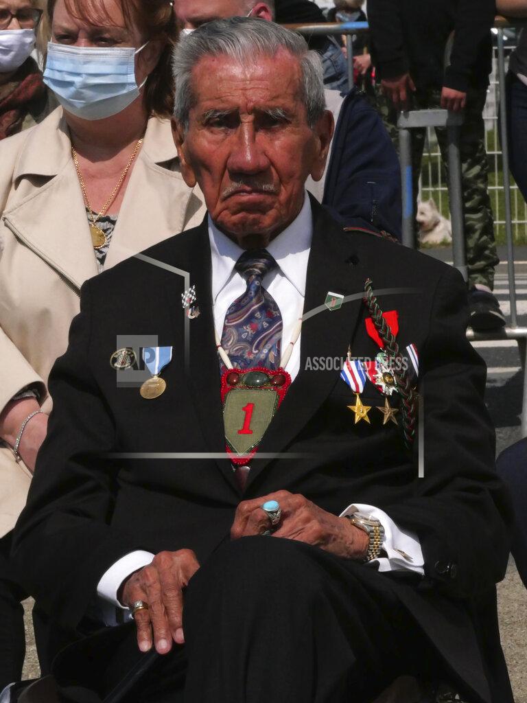 Nicolas Garriga Charles Shay, right, the 96-year-old native American from Indian Island, Maine, attends a D-Day ceremony in Carentan, Normandy, Friday, June 4, 2021. In a small Normandy town where paratroopers landed in the early hours of D-Day, applauds broke the silence to honor Charles Shay. He was the only veteran to attend the ceremony in Carentan commemorating the 77th anniversary of the assault that led to the end World War II. Shay was a 19-year-old U.S. Army medic when he landed on Omaha Beach. (AP Photo/Nicolas Garriga)