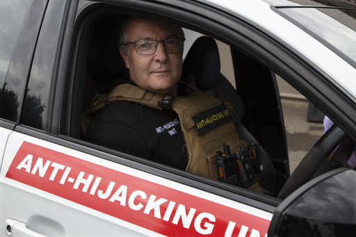 Anton Koen, a former police officer who now runs a private security firm that specializes in tracking and recovering hijacked and stolen vehicles, prepares to go out on patrol east of Johannesburg, South Africa, Tuesday, Nov. 28, 2023. Experts have warned that the South African police are losing the battle against crime and that has led those citizens who can afford it, to turn to a booming private security industry. (AP Photo/Denis Farrell)