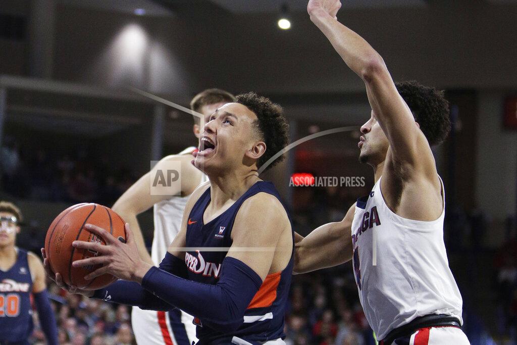 Young Kwak Pepperdine guard Colbey Ross, left, drives to the basket while pressured by Gonzaga guard Ryan Woolridge during the first half of an NCAA college basketball game in Spokane, Wash., Saturday, Jan. 4, 2020. (AP Photo/Young Kwak)