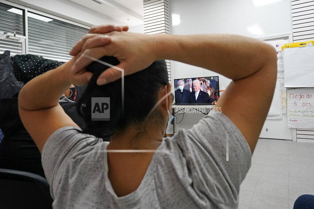Kathy Willens Graciela Uraga, a cleaning lady, watches President Joe Biden's inauguration with other immigrants at the Workers Justice Center, Wednesday, Jan. 20, 2021, in the Sunset Park neighborhood of Brooklyn in New York. (AP Photo/Kathy Willens)