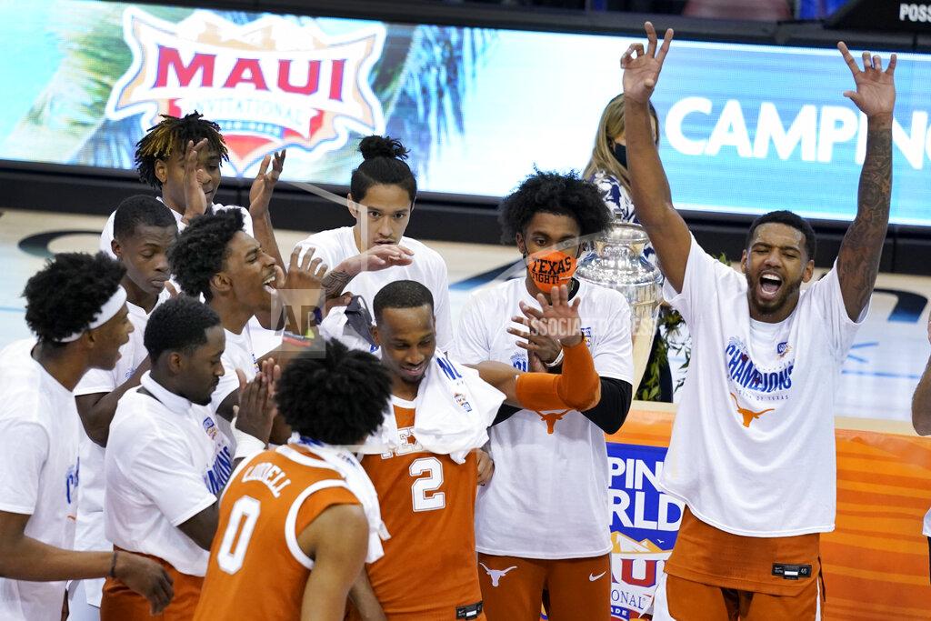 Kathy Kmonicek Texas guard Matt Coleman III (2) celebrates with teammates after they defeated North Carolina in an NCAA college basketball game for teh championship of the Maui Invitational, Wednesday, Dec. 2, 2020, in Asheville, N.C. (AP Photo/Kathy Kmonicek)