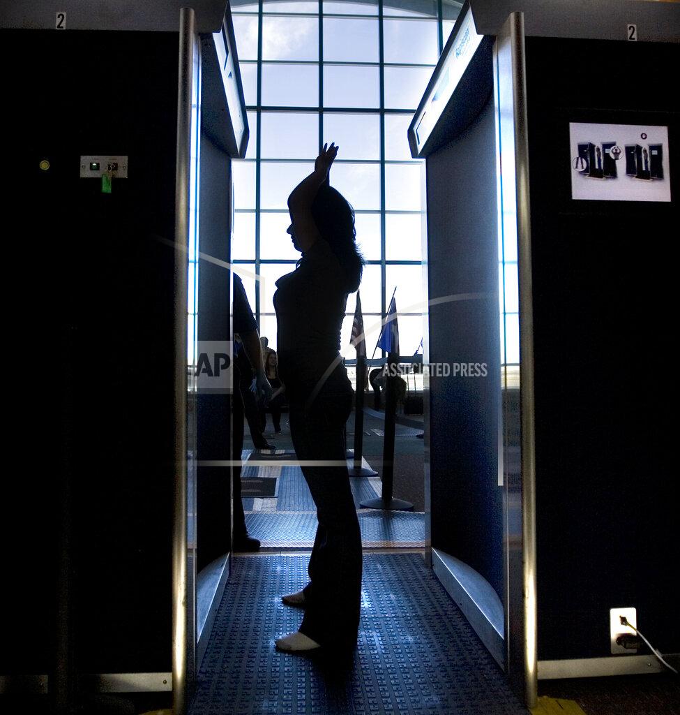 Mark Lambie FILE - In this Nov. 24, 2010, file photo. an unidentified passenger participates in a full-body scan at the El Paso International Airport in El Paso, Texas. The metal detectors that greet sports fans at the gates might soon be accompanied by thermal body scanners, in the gargantuan task of better protecting venues from virus spread in order to bring the games back for in-person viewing. (Mark Lambie/The El Paso Times via AP, File)