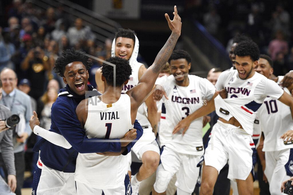 Jessica Hill Connecticut's Temi Aiyegbusi embraces Connecticut's Christian Vital (1) at the end of an NCAA college basketball game against Houston, Thursday, March 5, 2020, in Storrs, Conn. (AP Photo/Jessica Hill)