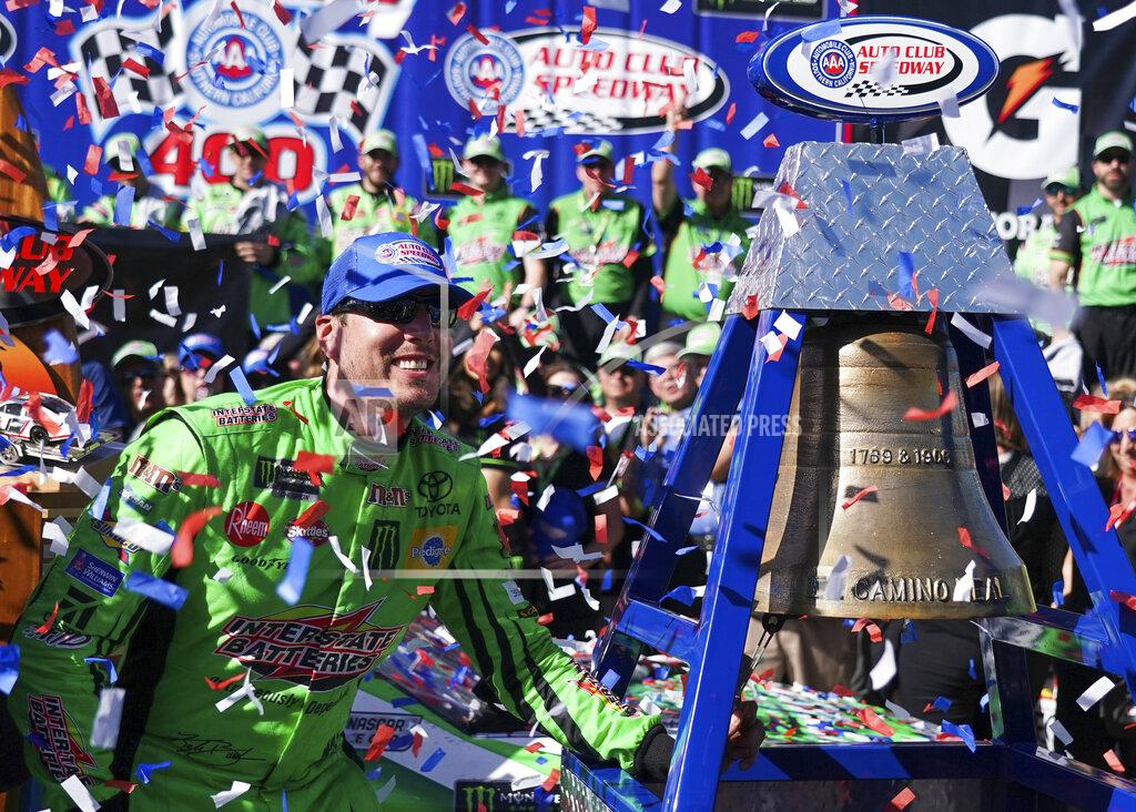 Rachel Luna Kyle Busch celebrates after winning a NASCAR Cup Series auto race at Auto Club Speedway, in Fontana, Calif., Sunday, March 17, 2019. (AP Photo/Rachel Luna)