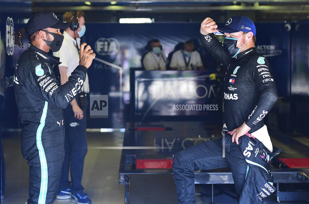 Jennifer Lorenzini Mercedes driver Lewis Hamilton, left, of Britain talks with his teammate Valtteri Bottas of Finland after clocking the fastest time during the qualifying session for Sunday's Italian Formula One Grand Prix, at the Monza racetrack in Monza, Italy, Saturday, Sept. 5, 2020. (Jennifer Lorenzini/Pool via AP)