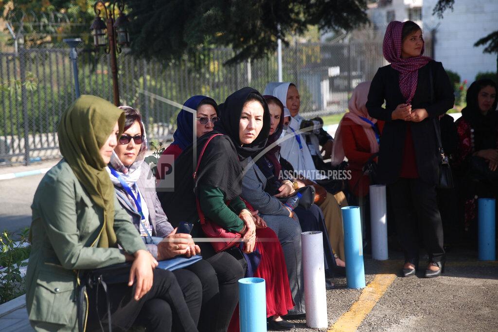 Rahmat Gul Delegates wait for transportation on the first day of the Afghan Loya Jirga meeting in Kabul, Afghanistan, Friday, Aug. 7, 2020. The traditional council opened Friday in the Afghan capital to decide the release of a final 400 Taliban - the final hurdle to the start of negotiations between Kabul’s leadership and the Taliban in keeping with a peace deal the United States signed with the insurgent movement in February. (AP Photo/Rahmat Gul)