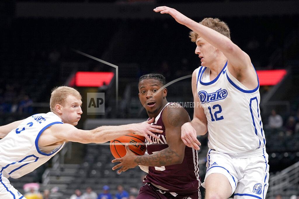 Jeff Roberson Southern Illinois' Lance Jones, center, heads to the basket as Drake's Garrett Sturtz, left, and Tucker Devries (12) defend during the second half of an NCAA college basketball game in the quarterfinal round of the Missouri Valley Conference tournament Friday, March 4, 2022, in St. Louis. (AP Photo/Jeff Roberson)
