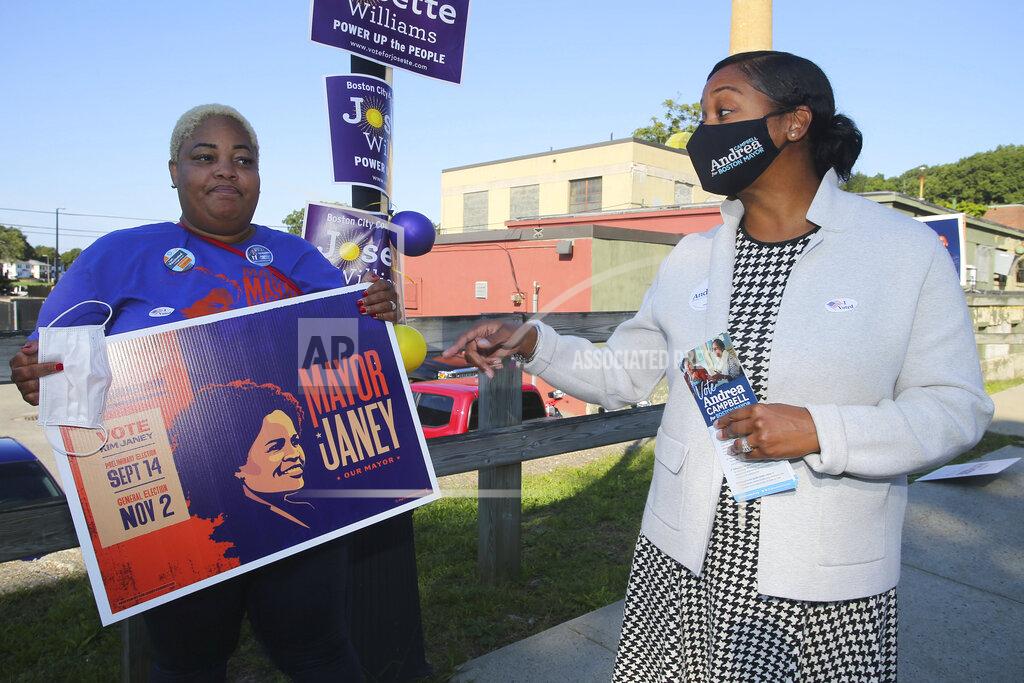 Stew Milne Boston mayoral candidate Andrea Campbell, right, talks with Aisha Miller, a supporter of Mayor Kim Janey, outside the Groveland Community Room in Boston, Tuesday, Sept. 14, 2021. On Tuesday, voters cast ballots in a preliminary mayoral election that will select two top contenders from a field of five main candidates all of whom are people of color, four of them women. (AP Photo/Stew Milne)
