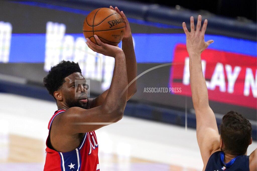 Tony Gutierrez Philadelphia 76ers center Joel Embiid (21) takes a shot over Dallas Mavericks forward Maxi Kleber, right, in the second half of an NBA basketball game in Dallas, Monday, April 12, 2021. (AP Photo/Tony Gutierrez)