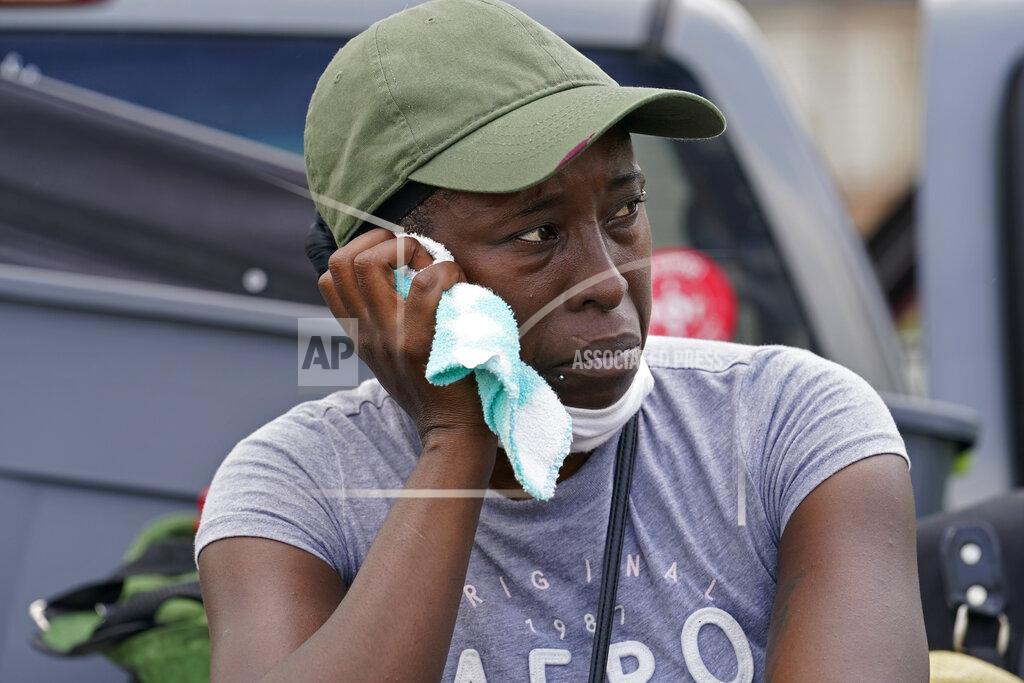 Gerald Herbert Linda Smoot, who evacuated from Hurricane Laura in a pickup truck with eight others, reacts as she returns to see her niece's damaged home, in Lake Charles, La., in the aftermath of the hurricane, Sunday, Aug. 30, 2020. (AP Photo/Gerald Herbert)