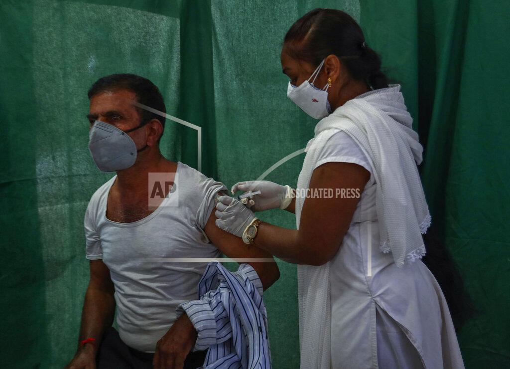 Mahesh Kumar A. FILE - In this April 19, 2021, file photo, a health worker administers a vaccine for COVID-19 in Hyderabad, India. As deaths mount and a vaccine rollout falters badly, Prime Minister Narendra Modi has pushed much of the responsibility for fighting the outbreak onto unprepared and poorly equipped state governments. The crisis has badly dented Modi’s carefully cultivated image as an able technocrat. (AP Photo/Mahesh Kumar A., File)