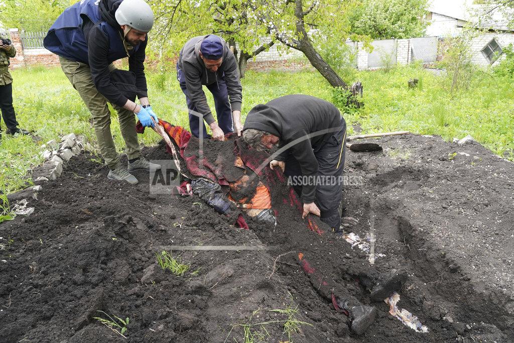Andrii Marienko Police and volunteers exhume the bodies of civilians killed by Russian shelling in the village of Stepaky, close to Kharkiv, Ukraine, Wednesday, May 11, 2022. (AP Photo/Andrii Marienko)
