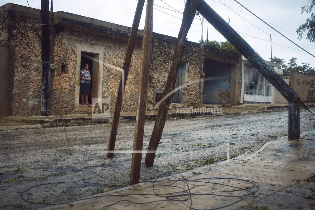 Andres Kudacki A woman stands at her doorway after the passing of Hurricane Delta in Tizimin, Mexico, Wednesday, Oct. 7, 2020. Hurricane Delta made landfall Wednesday just south of the Mexican resort of Cancun as a Category 2 storm, downing trees and knocking out power to some resorts along the northeastern coast of the Yucatan Peninsula. (AP Photo/Andres Kudacki)