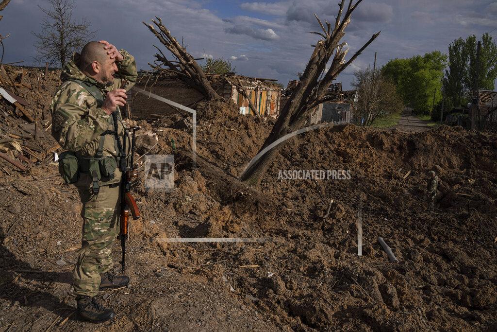 Evgeniy Maloletka A Ukrainian serviceman inspects a site after an airstrike by Russian forces in Bahmut, Ukraine, Tuesday, May 10, 2022. (AP Photo/Evgeniy Maloletka)