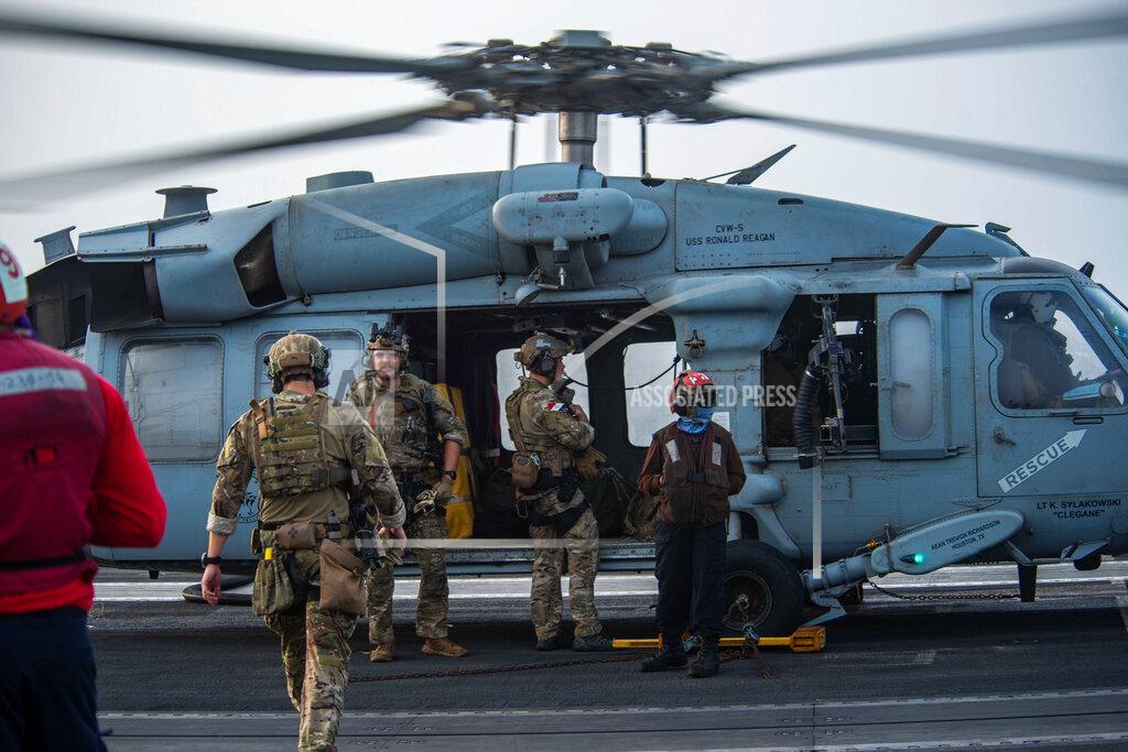 Mass Communication Specialist 2Nd Class Quinton A. Lee In this photo provided by the U.S. Navy, sailors assigned to an explosive ordnance unit board an MH-60S Seahawk helicopter on the flight deck of aircraft carrier USS Ronald Reagan to head to an oil tanker that was attacked off the coast of Oman in the Arabian Sea on Friday, July 30, 2021. An attack on an oil tanker linked to an Israeli billionaire killed two crew members off Oman in the Arabian Sea, authorities said Friday, marking the first fatalities after years of assaults targeting shipping in the region. (Mass Communication Specialist 2nd Class Quinton A. Lee/U.S. Navy, via AP)