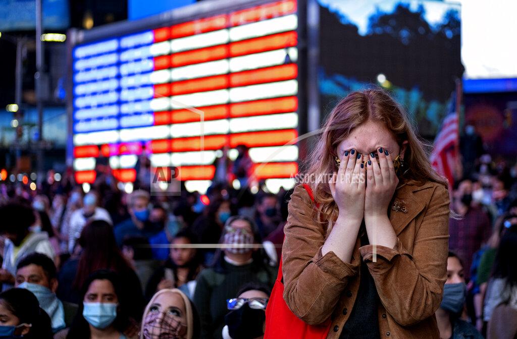 Craig Ruttle Fletcher Peters of New York, a journalism student at NYU, reacts as she watches President-elect Joe Biden on a monitor in Times Square on Saturday, Nov. 7, 2020, in New York, as he addressed the nation. (AP Photo/Craig Ruttle)