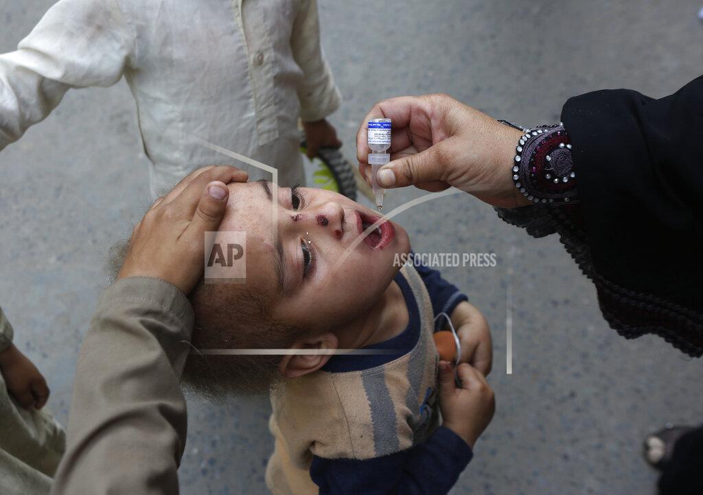 K.m. Chaudary A health worker administers a polio vaccine to a child in Lahore, Pakistan, Monday, March 29, 2021. Despite a steady rise in coronavirus cases, Pakistan on Monday launched a five-day vaccination campaign against polio amid tight security, hoping to eradicate the crippling children's disease this year. (AP Photo/K.M. Chaudary)