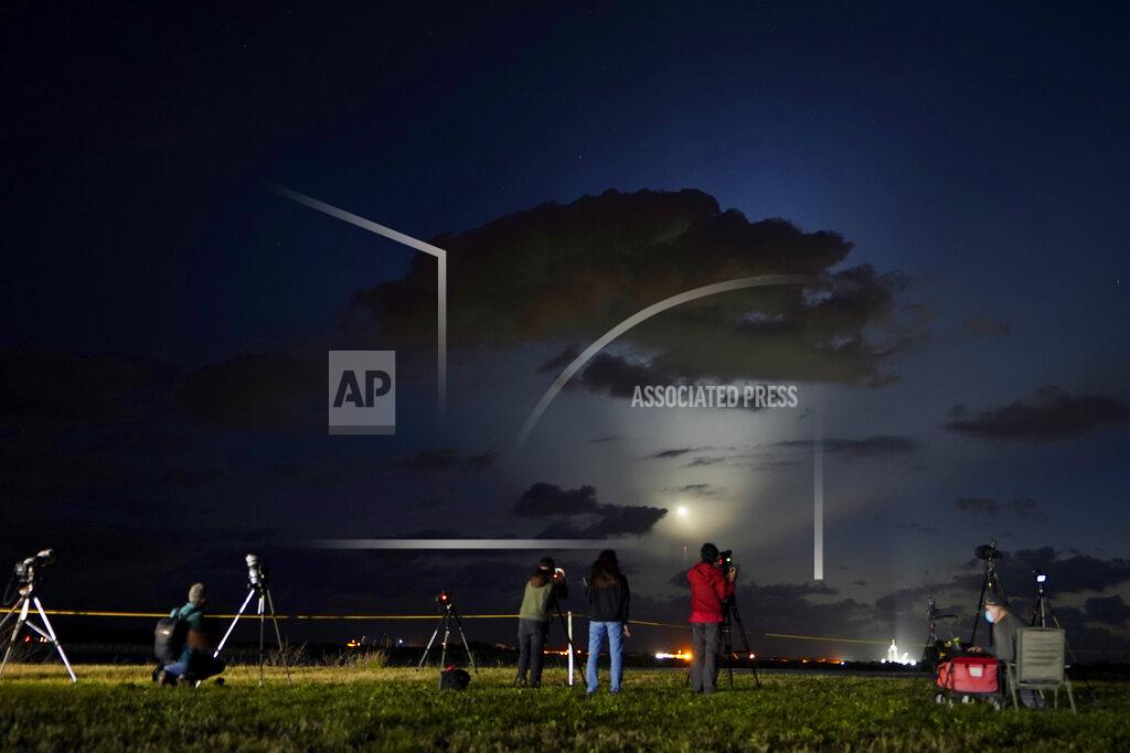 Brynn Anderson Photographers watch SpaceX Falcon 9 rocket with the Crew Dragon space capsule lift off from pad 39A at the Kennedy Space Center in Cape Canaveral, Fla., Friday, April 23, 2021. (AP Photo/Brynn Anderson)