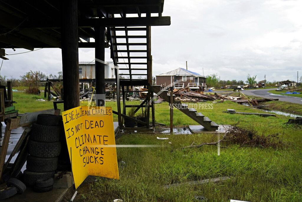 Gerald Herbert Storm clouds from Tropical Storm Nicholas are seen behind homes of the vanishing Native American community of Isle de Jean Charles, La., which were destroyed by Hurricane Ida, Tuesday, Sept. 14, 2021. (AP Photo/Gerald Herbert)