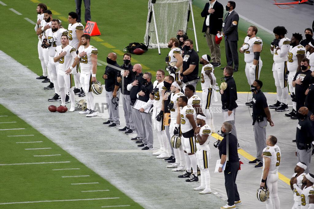 Isaac Brekken New Orleans Saints plays stand during the national anthem before an NFL football game against the Las Vegas Raiders, Monday, Sept. 21, 2020, in Las Vegas. (AP Photo/Isaac Brekken)