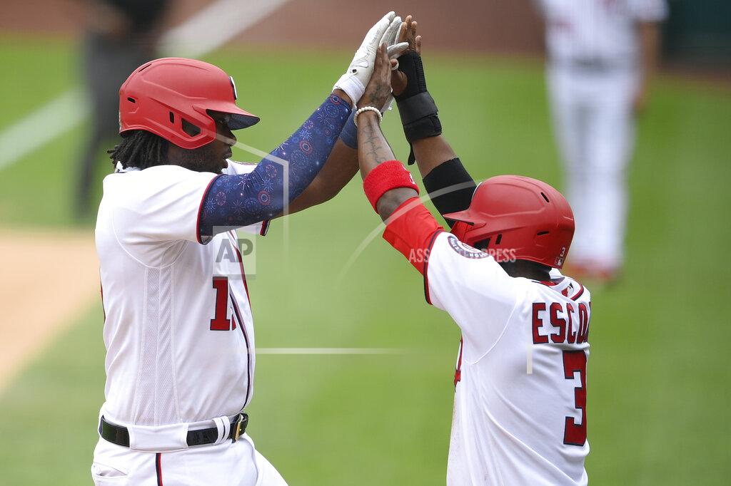 Nick Wass Washington Nationals' Josh Bell, left, celebrates his two-run home run with Alcides Escobar, right, during the first inning of a baseball game against the New York Mets, Sunday, Sept. 5, 2021, in Washington. (AP Photo/Nick Wass)