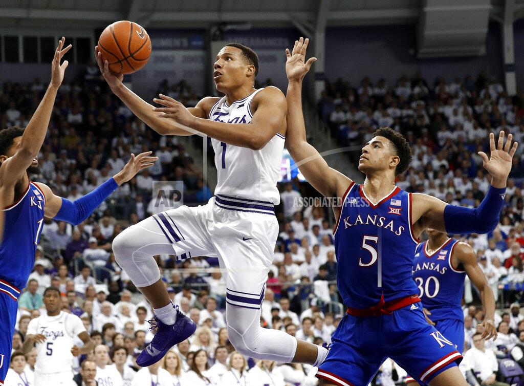 Tony Gutierrez Kansas forward Dedric Lawson (1) and guard Quentin Grimes (5) defend as TCU guard Desmond Bane (1) leaps to the basket for a shot in the second half of an NCAA college basketball game in Fort Worth, Texas, Monday, Feb. 11, 2019. (AP Photo/Tony Gutierrez)