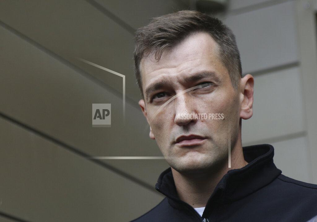 FILE In this file photo taken on Friday, Aug. 21, 2020, Oleg Navalny, Alexei Navalny's brother speaks to the media at the Omsk Ambulance Hospital No. 1, intensive care unit where Alexei Navalny was hospitalized in Omsk, Russia. Navalny's brother, Oleg; his top ally, Lyubov Sobol; Oleg Stepanov, the head of Navalny's Moscow office; Dr. Anastasia Vasilyeva from the Navalny-backed Alliance of Doctors; and Maria Alekhina from the Pussy Riot punk collective were detained for 48 hours as part of a criminal probe into alleged violations of coronavirus regulations during last weekend's protests. Moscow's Tverskoy District Court put Stepanov under house arrest until March 23 as requested by investigators. The cases of the four others were to be heard later Friday. (AP Photo/Evgeniy Sofiychuk, File)