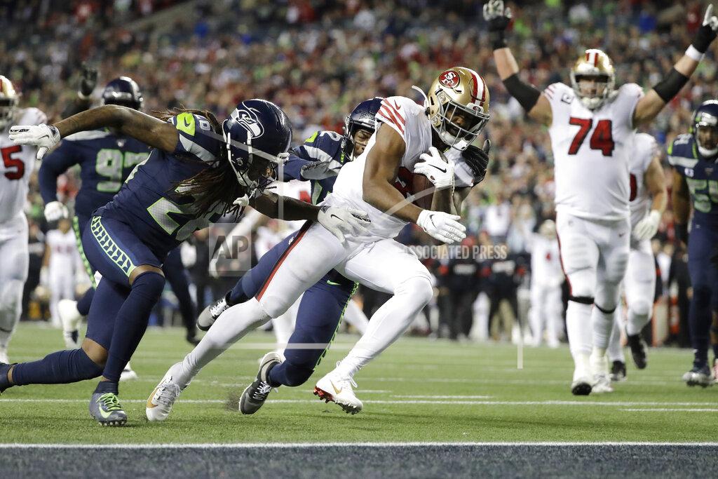 Ted S. Warren San Francisco 49ers' Raheem Mostert scores against the Seattle Seahawks during the second half of an NFL football game, Sunday, Dec. 29, 2019, in Seattle. (AP Photo/Ted S. Warren)